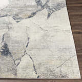 Close up of the Gasquet Gray Marble Textured Luxe Rug showing its charcoal, gray, and yellow pattern. Front