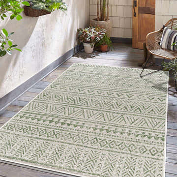 Outdoor patio scene with a Novato Olive All Over Pattern Performance Rug, plants, wood floors, and a wicker chair. Roomscene-Rectangle