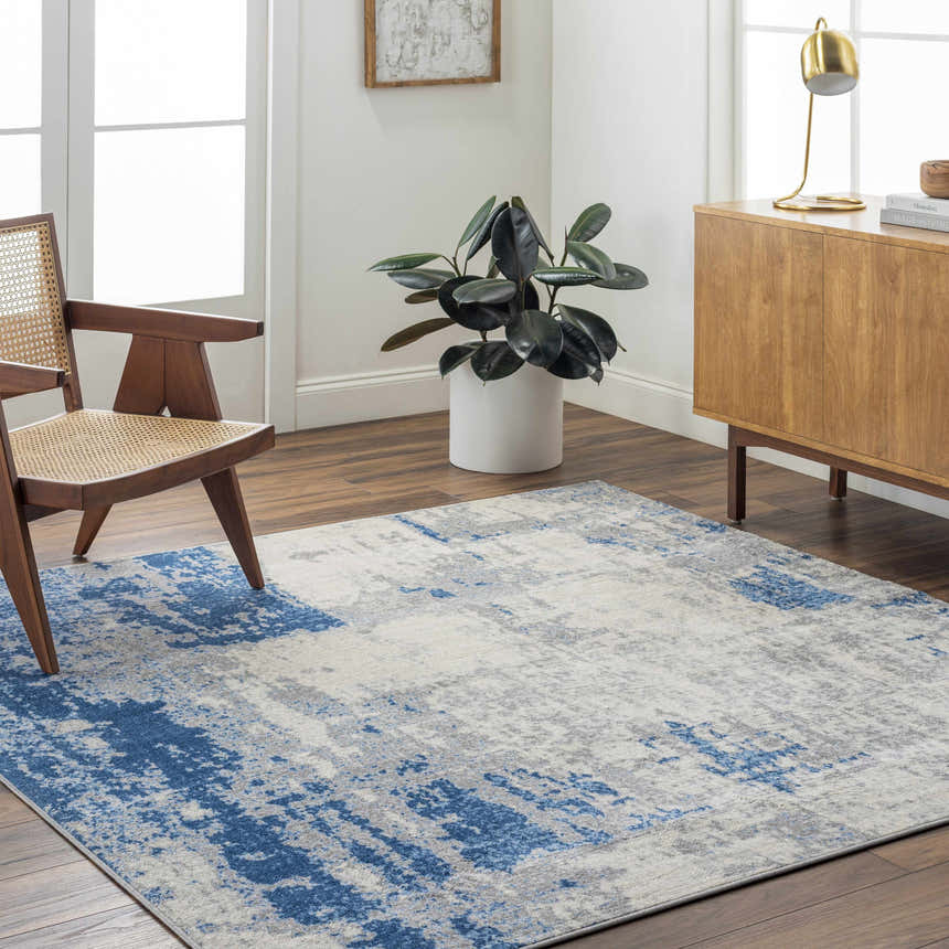 Living room scene with a blue and gray Gerton Area Rug, wood floors, and mid-century modern furniture. Roomscene-Rectangle