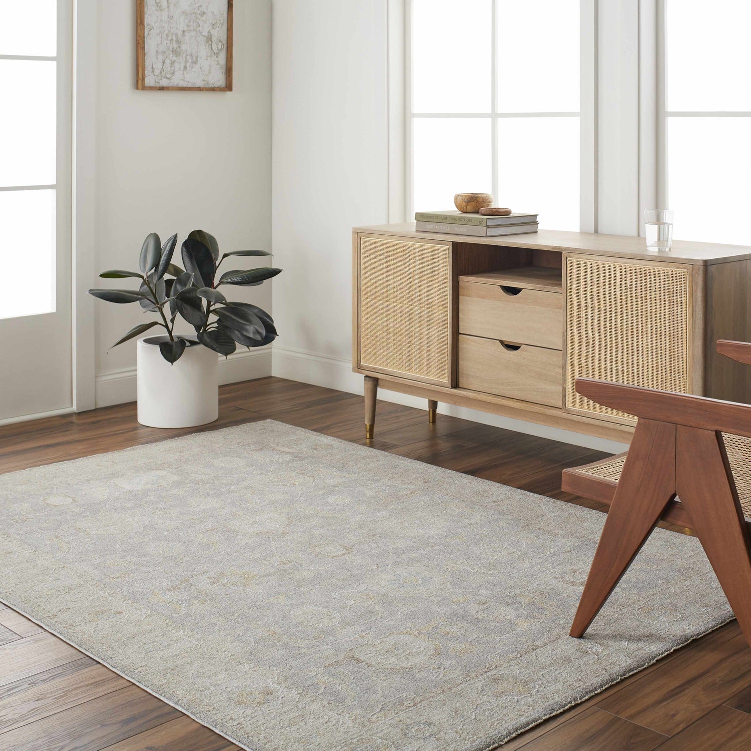 Living room scene with a Beachhouse Giang Thick Luxe Area Rug, wood floors, and a rattan cabinet. Roomscene-Rectangle