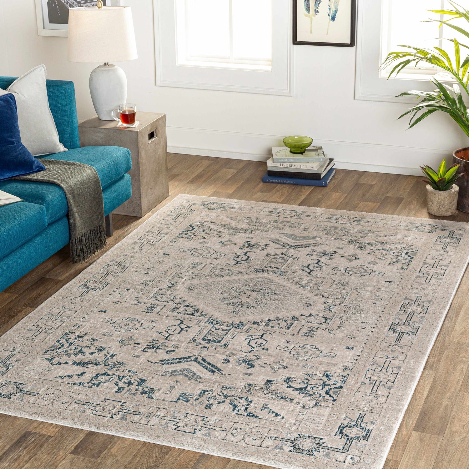 Living room with a teal sofa and the Girikbedro Area Carpet in cream, gray, and teal. Roomscene-Rectangle
