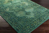 Close-up of the hand-tufted Gilbertsville Area Rug. Green, teal, and sage tones with a vintage oriental pattern. 100% wool texture. Corner