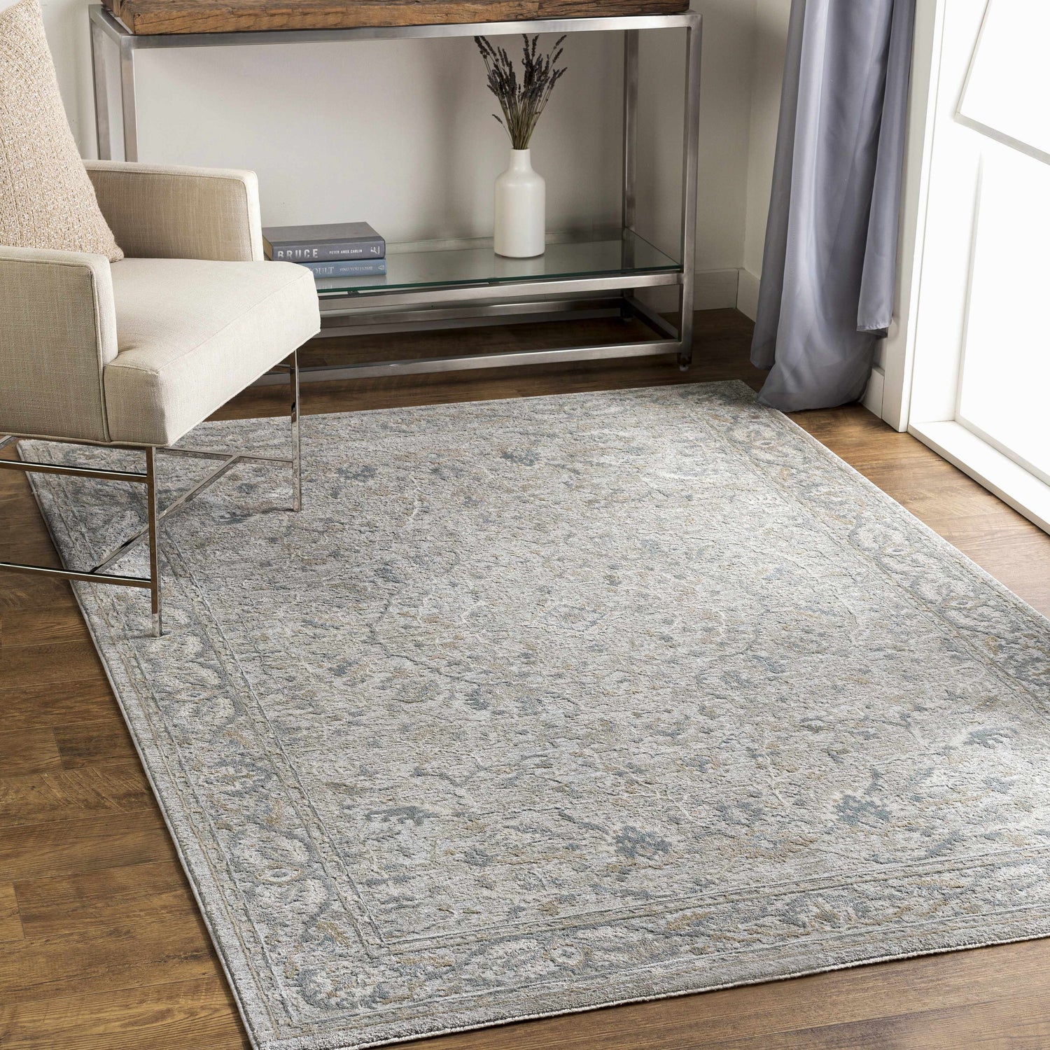 Living room scene with a Glengarry Thick Luxe Boutique Rug in dusty sage, light beige, and gray under a chair. Roomscene-Rectangle