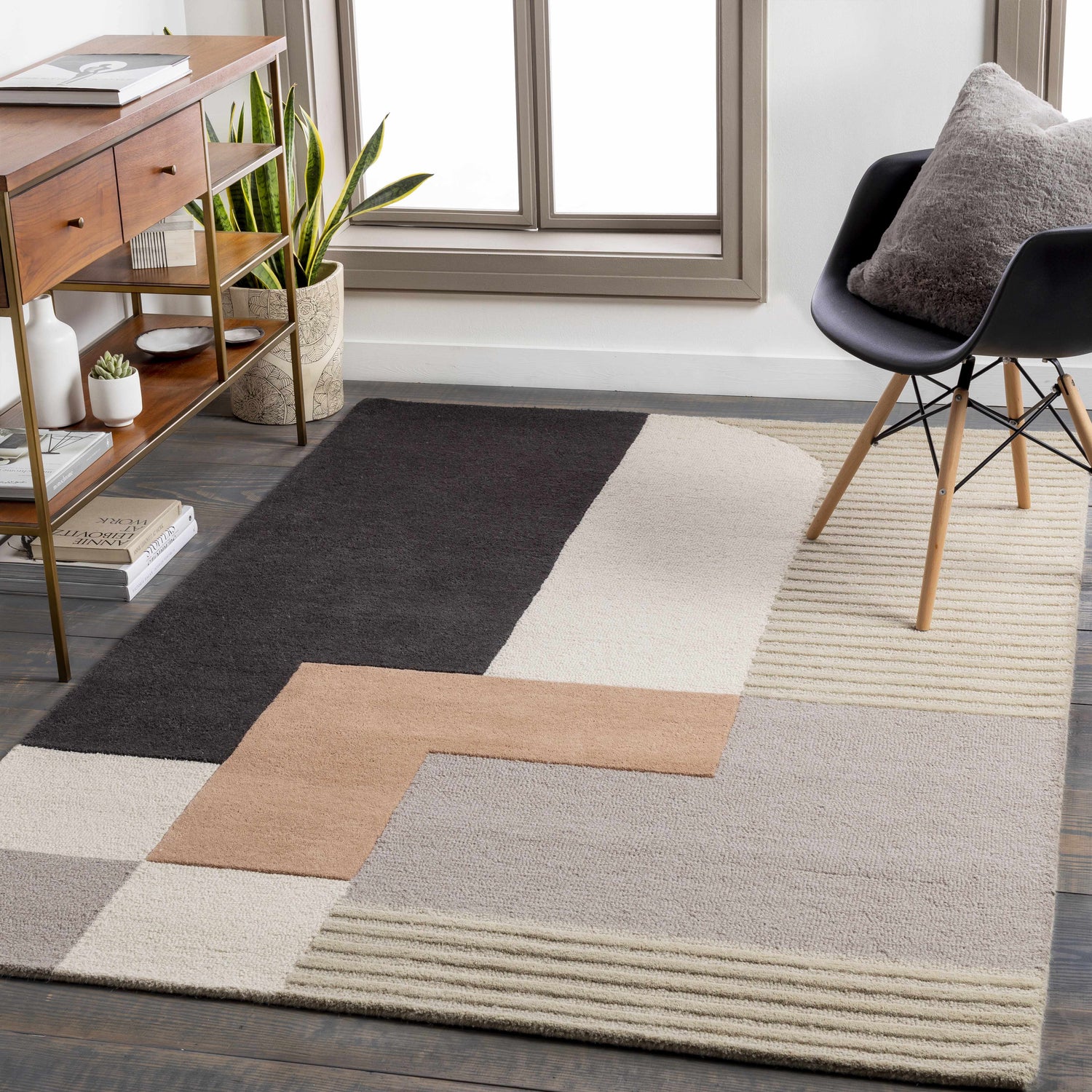 Modern living room with geometric Glenmavis Area Rug in black, beige, gray, and peach. Mid-century console table and chair. Roomscene-Rectangle