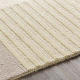 Close-up of the Glenmavis Area Rug, a hand-tufted wool rug with beige and light gray geometric stripes. Texture