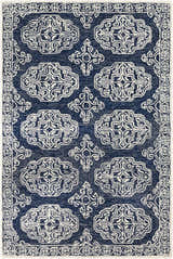 Close-up of the Glenoma Blue Regency Wool Rug, featuring a detailed beige pattern on a navy background and a decorative border. Design-Rectangle-576