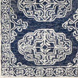 Close up of the Glenoma Blue Regency Wool Rug, featuring a detailed white geometric and floral pattern on navy. Swatch