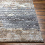 Close-up of Gonen Thick Luxe Rug showing gray, brown, and white abstract pattern and plush texture on wood floor. Front