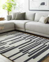 Living room scene with gray sectional sofa and black and white Walid Area Rug. Roomscene-Rectangle