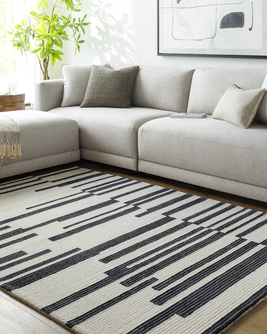 Living room scene with gray sectional sofa and black and white Walid Area Rug. Roomscene-Rectangle