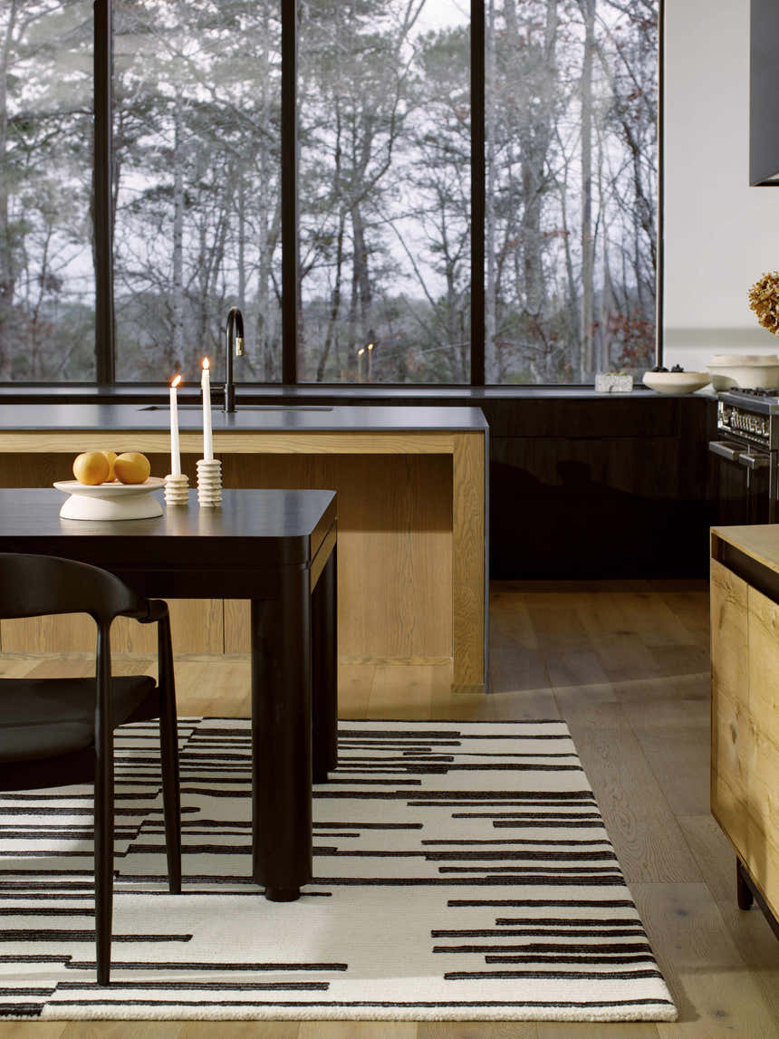 Modern kitchen scene with a black table and the ash and black Walid Area Rug. Roomscene-Rectangle