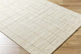 Close-up of the Ailani Area Rug. Ash and pearl wool rug with a hand-tufted, farmhouse-style grid pattern. Corner
