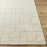 Close-up of the hand-tufted Ailani Area Rug. Ash and pearl wool rug with a farmhouse-style geometric grid pattern. Front