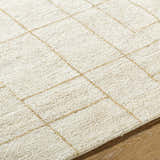 Close-up of the Ailani Area Rug. Hand-tufted wool rug in ash and pearl with a subtle geometric grid pattern. Farmhouse style. Texture