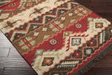 Close-up of the hand-woven Grimsby Wool Area Rug, featuring bohemian-style geometric patterns in burgundy, brown, and beige. Corner