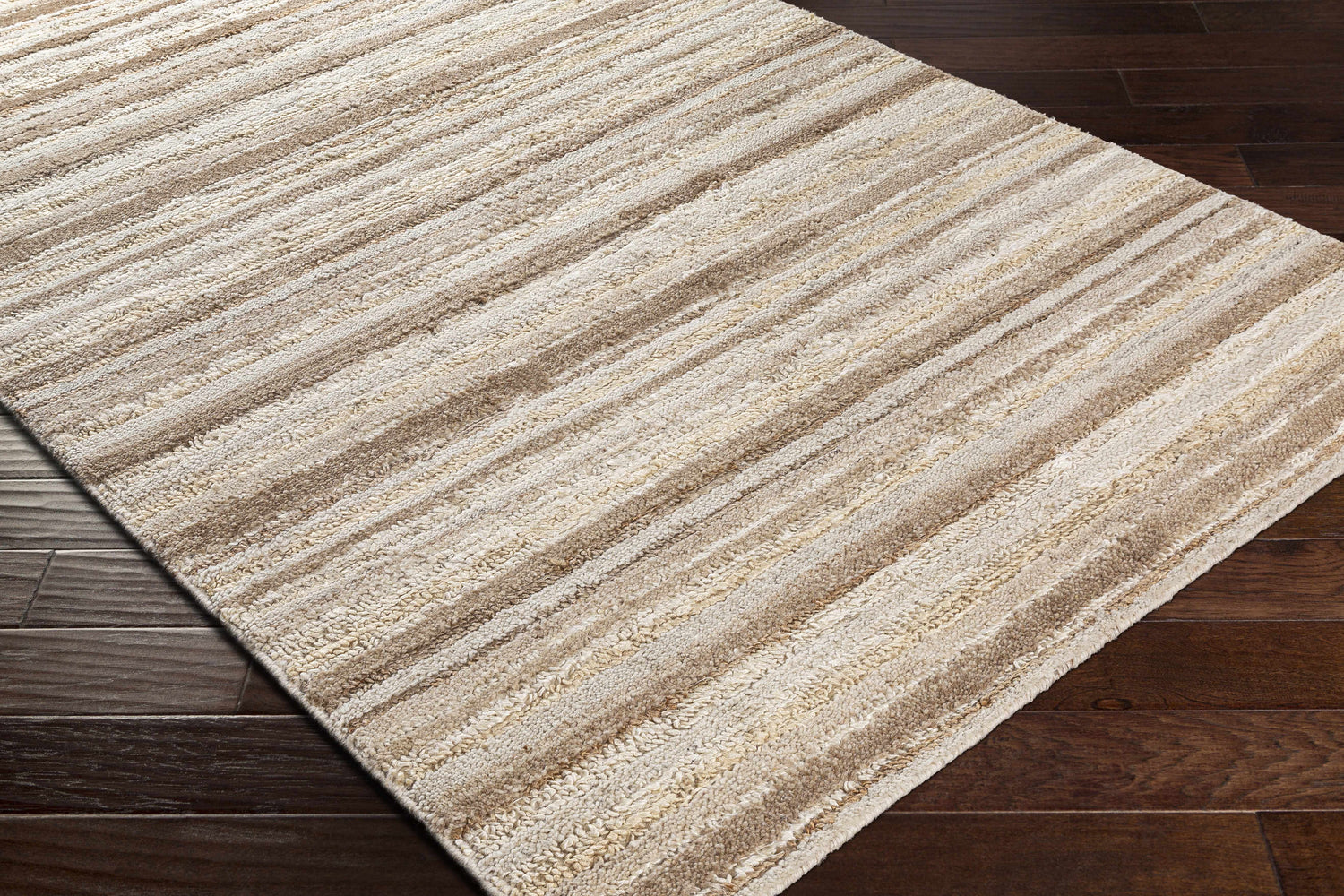 Close-up of the hand woven Greenbackvile Area Rug. Cream, beige, and brown stripes add texture and a contemporary style. Corner