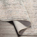 Close-up of the Guiwanon Area Rug showing its cream, gray, and peach traditional pattern and machine-woven texture. Fold