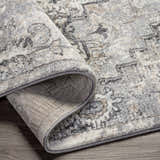 Close-up of the Hagdan Thick Luxe Rug showing its cream, gray, and beige oriental pattern and thick, plush texture. Fold