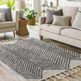 Living room scene with a charcoal and cream Halton Area Carpet, beige sofa, and light wood floors. Roomscene-Rectangle