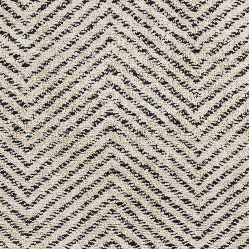 Close-up of the Halton Area Carpet showing a cream and charcoal chevron pattern, hand woven texture. Swatch