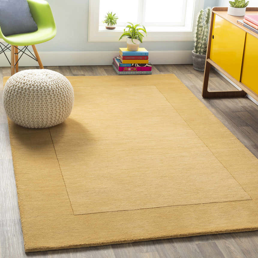 Bright living room with a Bordered Solid Camel Yellow Wool Rug, pouf, and yellow cabinet. Roomscene-Rectangle