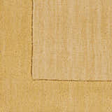 Close-up of a Bordered Solid Camel Yellow Wool Rug showing texture and border detail. Swatch