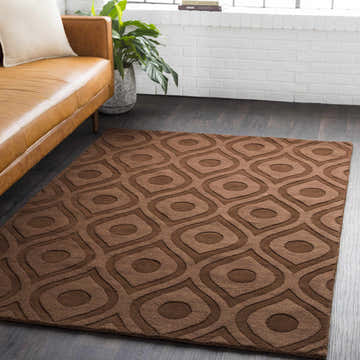 Living room scene with a brown leather sofa and a dark brown Hamptonville Area Rug with a contemporary geometric pattern. Roomscene-Rectangle