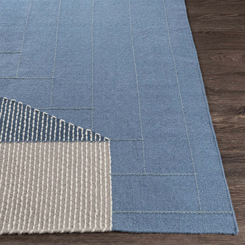 Close up of the Blue Hanwood wool rug showing braided texture and geometric pattern. Front