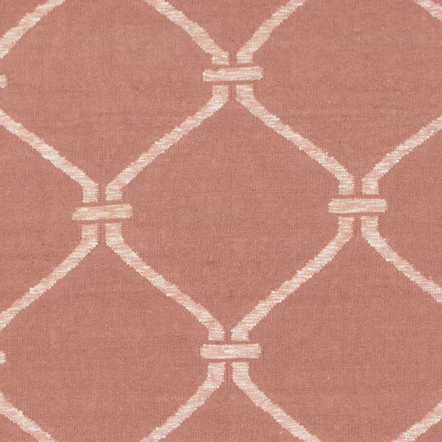 Close-up of Hazelhurst Area Carpet showing dusty pink wool with a light gray geometric trellis pattern. Swatch