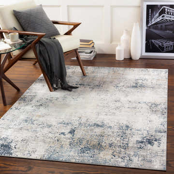 Living room scene with a Higden Abstract Denim Blue Rug, chair, side table, and decor. Warm and inviting. Roomscene-Rectangle