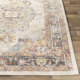 Close up of the Hillcrest Area Rug, a traditional design in beige, blue, and rust on a wood floor. Front