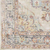 Close up of the Hillcrest Area Rug showing beige, blue, and rust traditional pattern. Swatch