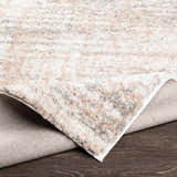 Close-up of the plush Hammond Dusty Pink Rug showing cream, gray, and pink tones and soft texture. Fold