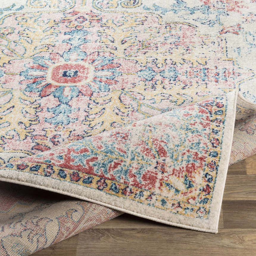 Close-up of the Hemingbrough Red&White Medallion Rug showing its red, blue, and saffron floral pattern and machine-woven texture. Fold