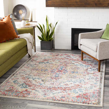 Living room scene with a Hemingbrough Red&White Medallion Rug, green sofa, gray chair, and white brick fireplace. Roomscene-Rectangle
