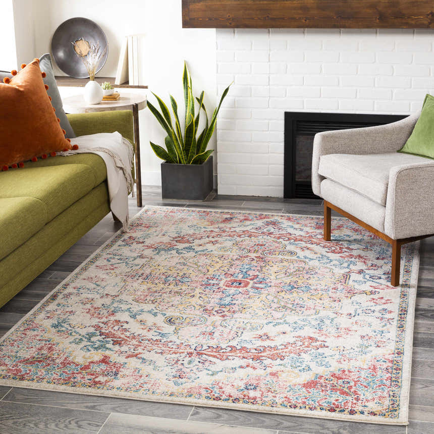 Living room scene with a Hemingbrough Red&White Medallion Rug, green sofa, gray chair, and white brick fireplace. Roomscene-Rectangle