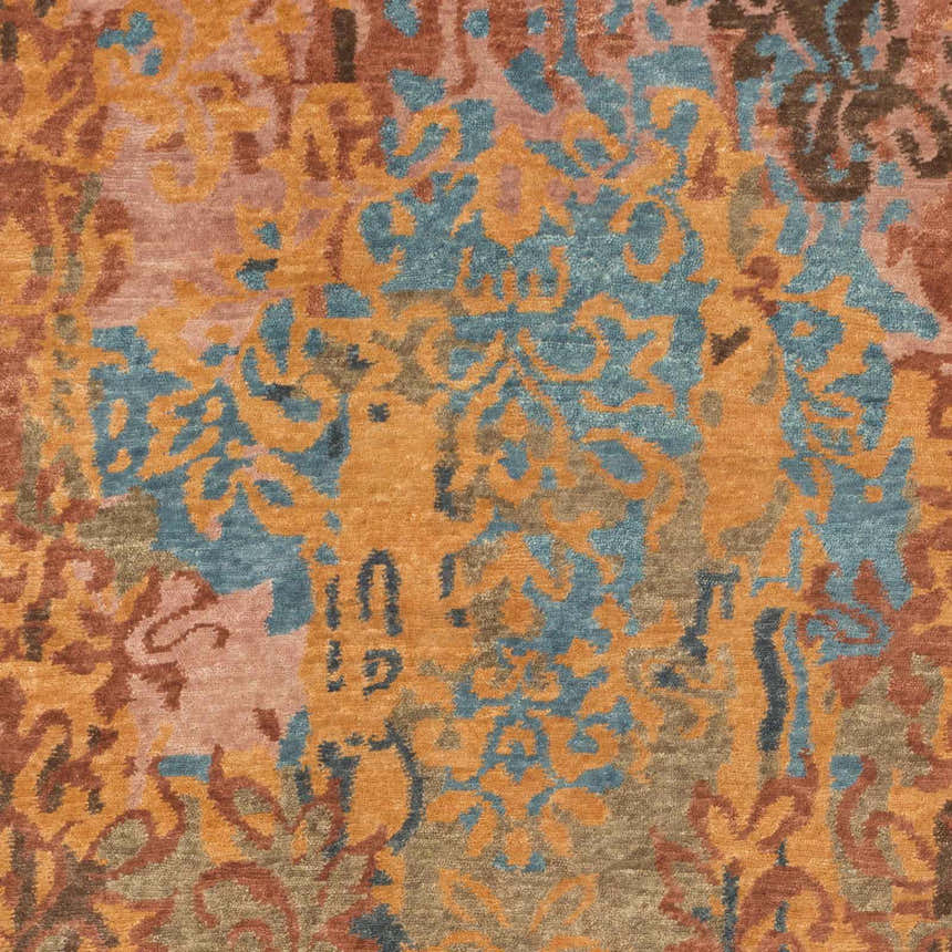 Close-up of the hand-knotted Homerville Area Rug. Features a contemporary floral pattern in rust, tan, and dark blue. Swatch