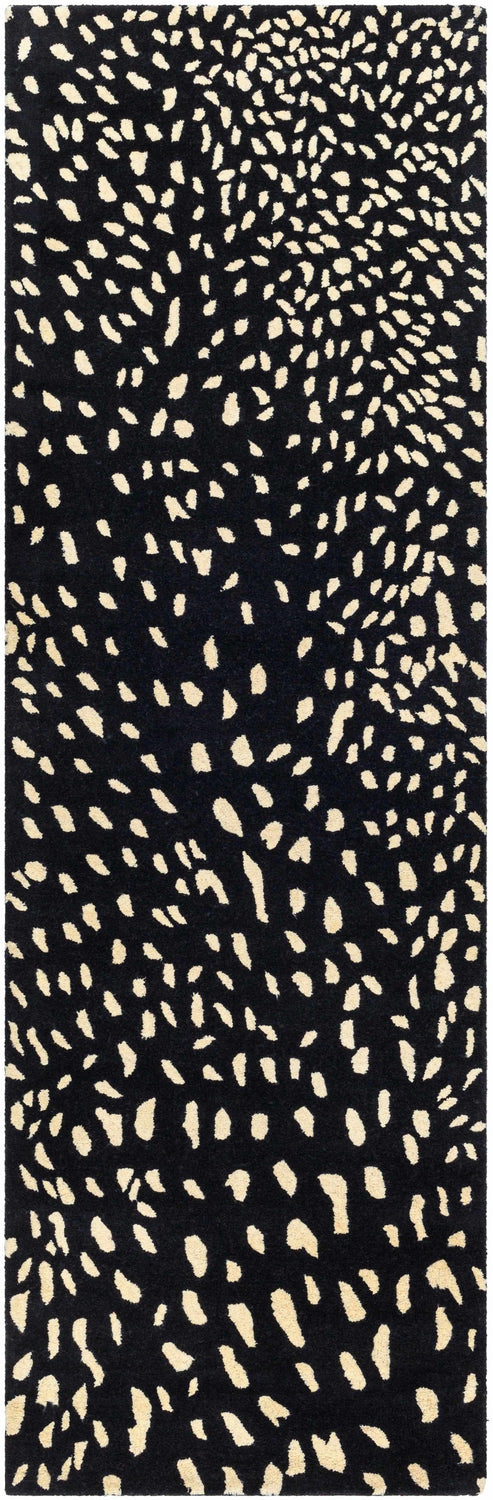 Close-up of the Athena Black Giraffe Print Wool Rug, featuring a beige animal print pattern on black, hand-tufted wool. Design-Runner-268