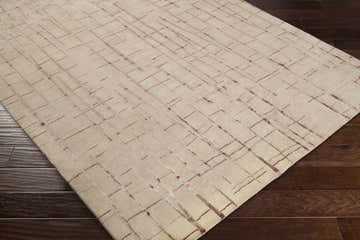 Close-up of the Hotchkiss Area Carpet showing its brick red and light brown geometric design and hand-knotted texture. Corner