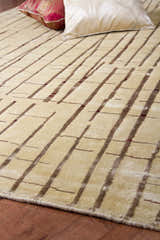 Close-up of the hand-knotted Hotchkiss Area Carpet. Brick red and light brown stripes on a mustard wool rug. Styleshot