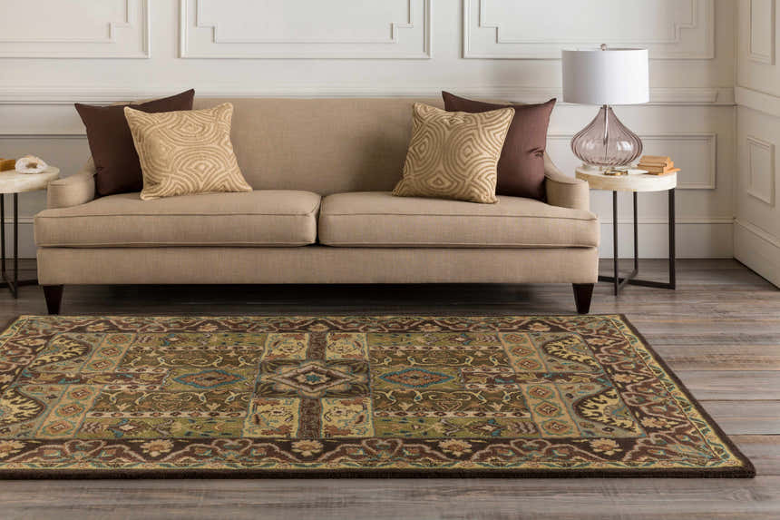Living room scene with a beige sofa and the Huguenot 12x15 wool rug in beige, brown, olive, and teal colors. Roomscene-Rectangle