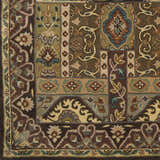 Close-up of the hand-tufted Huguenot 12x15 wool rug. Features a traditional floral pattern with beige, brown, olive, and teal accents. Swatch