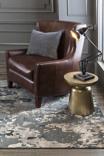 Living room scene with a brown leather chair on a blue and gray Ingomar Area Rug. Roomscene-Rectangle