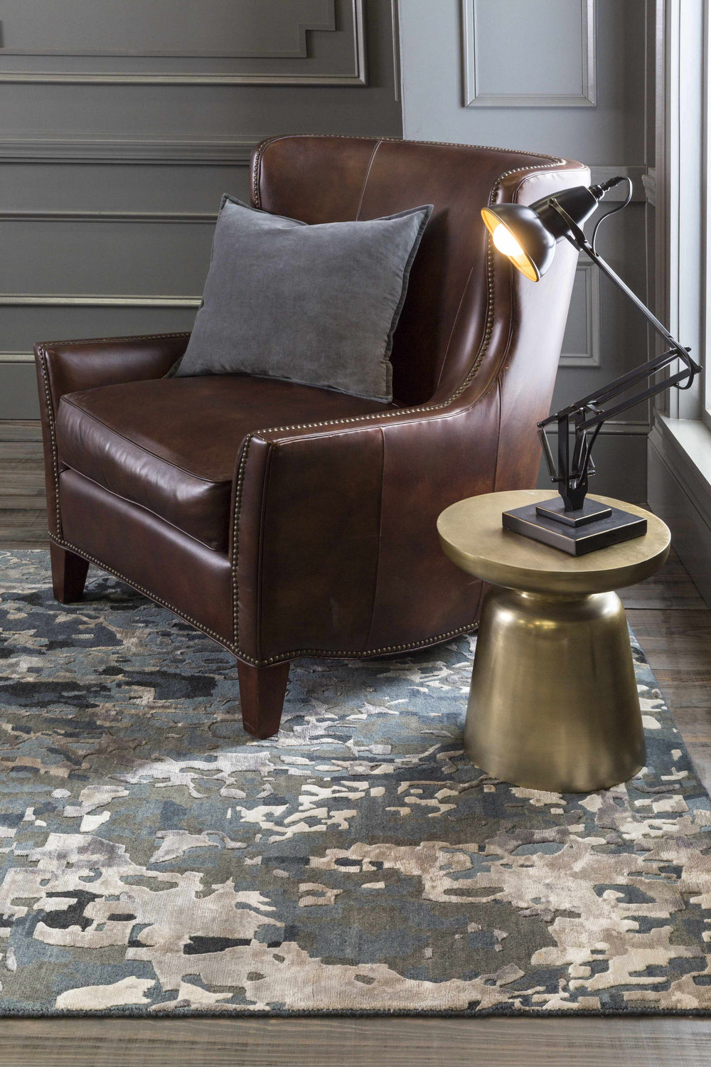 Living room scene with a brown leather chair on a blue and gray Ingomar Area Rug. Roomscene-Rectangle