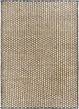 Close-up of the Iqaluit Natural Jute Rug. Hand-woven rug with black stripes on a light beige jute background. Contemporary style. Design-Rectangle-576
