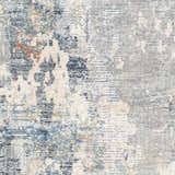 Close-up of the Iryna Area Rug showing its contemporary charcoal, gray, and brown abstract pattern and soft polyester texture. Swatch
