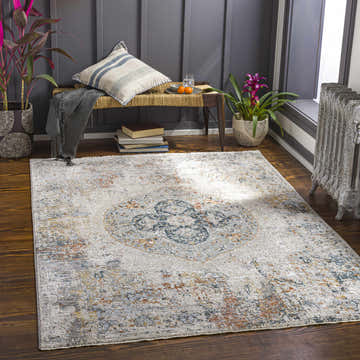 Cozy reading nook with Isaac Luxe Rug in brick red, charcoal, cream, and gray. Bench with throw and plants on dark wood floor. Roomscene-Rectangle