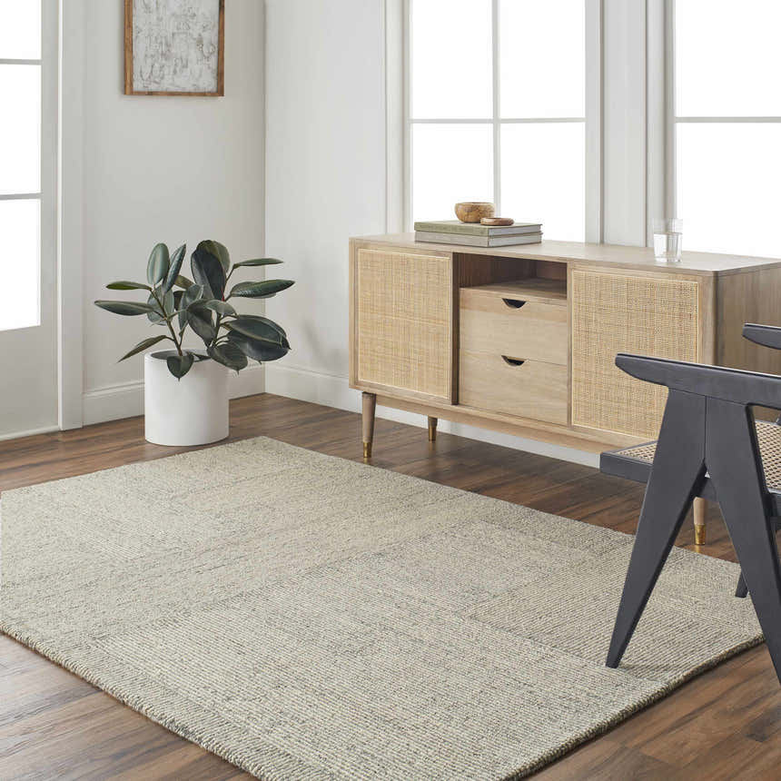 Living room scene with a dusty sage Isamu Area Rug, wood floors, and a light wood cabinet. Roomscene-Rectangle