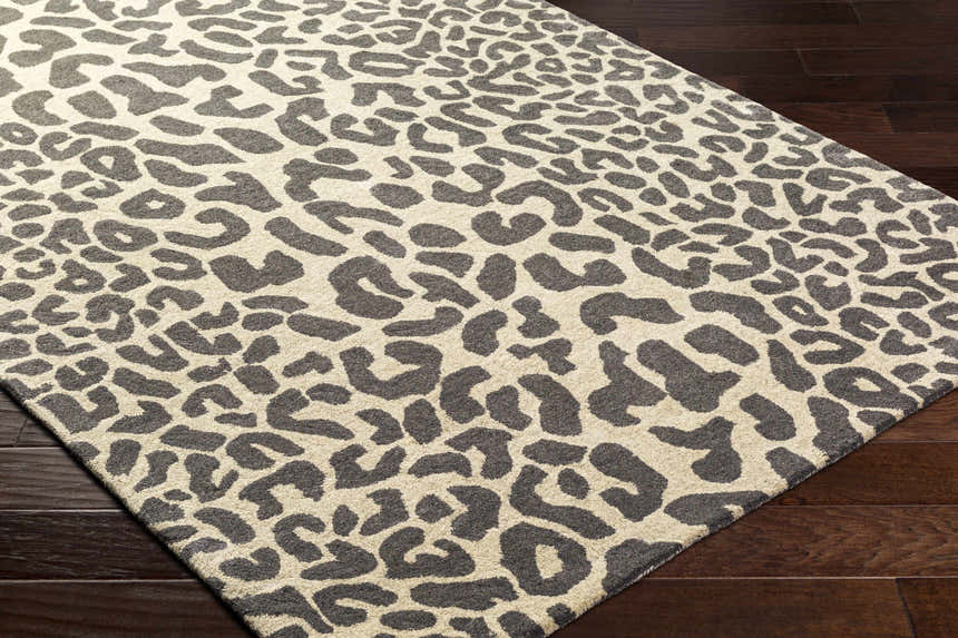 Close-up of the Iseul Leopard Print Area Rug showing its dark gray leopard spots on a taupe background. 100% Wool rug. Corner