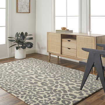 Living room scene with a gray Iseul Leopard Print Area Rug, wood floors, and a light wood mid-century modern cabinet. Roomscene-Rectangle